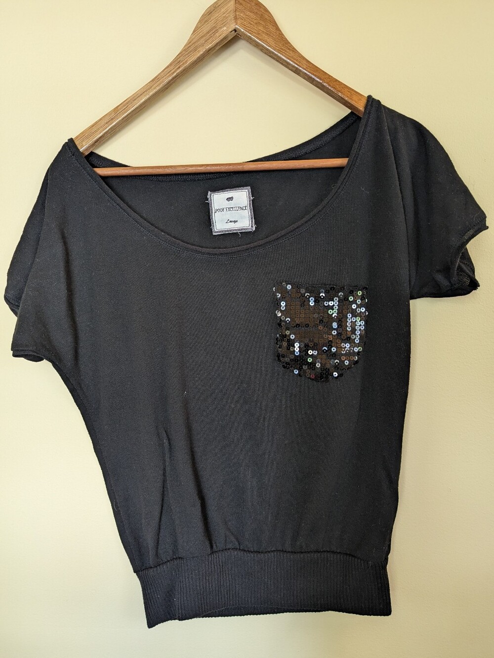 Black blouse with sequin pocket and elastic around bottom Size Large